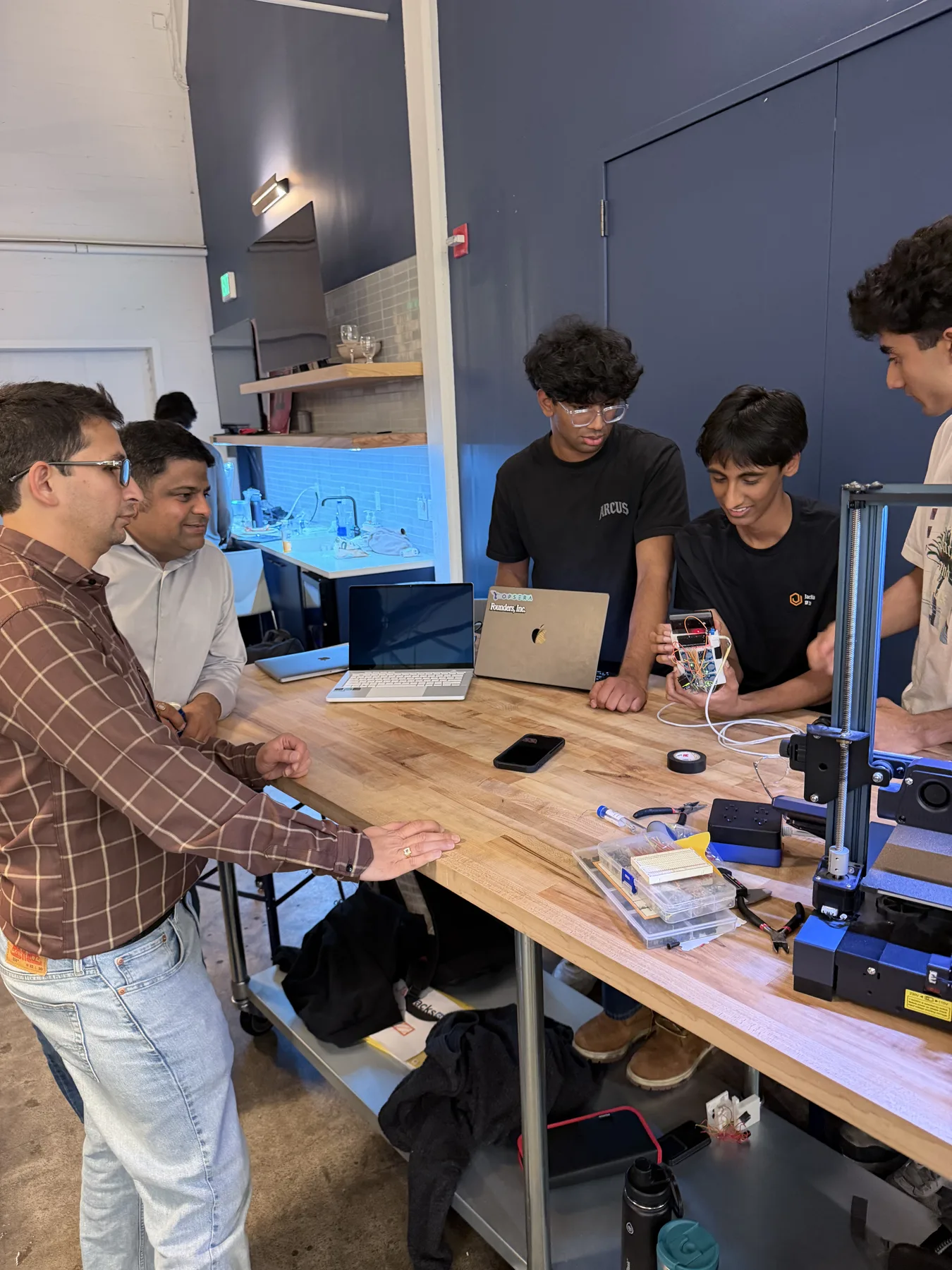 Team working on a 3D printer at JacHacks SF