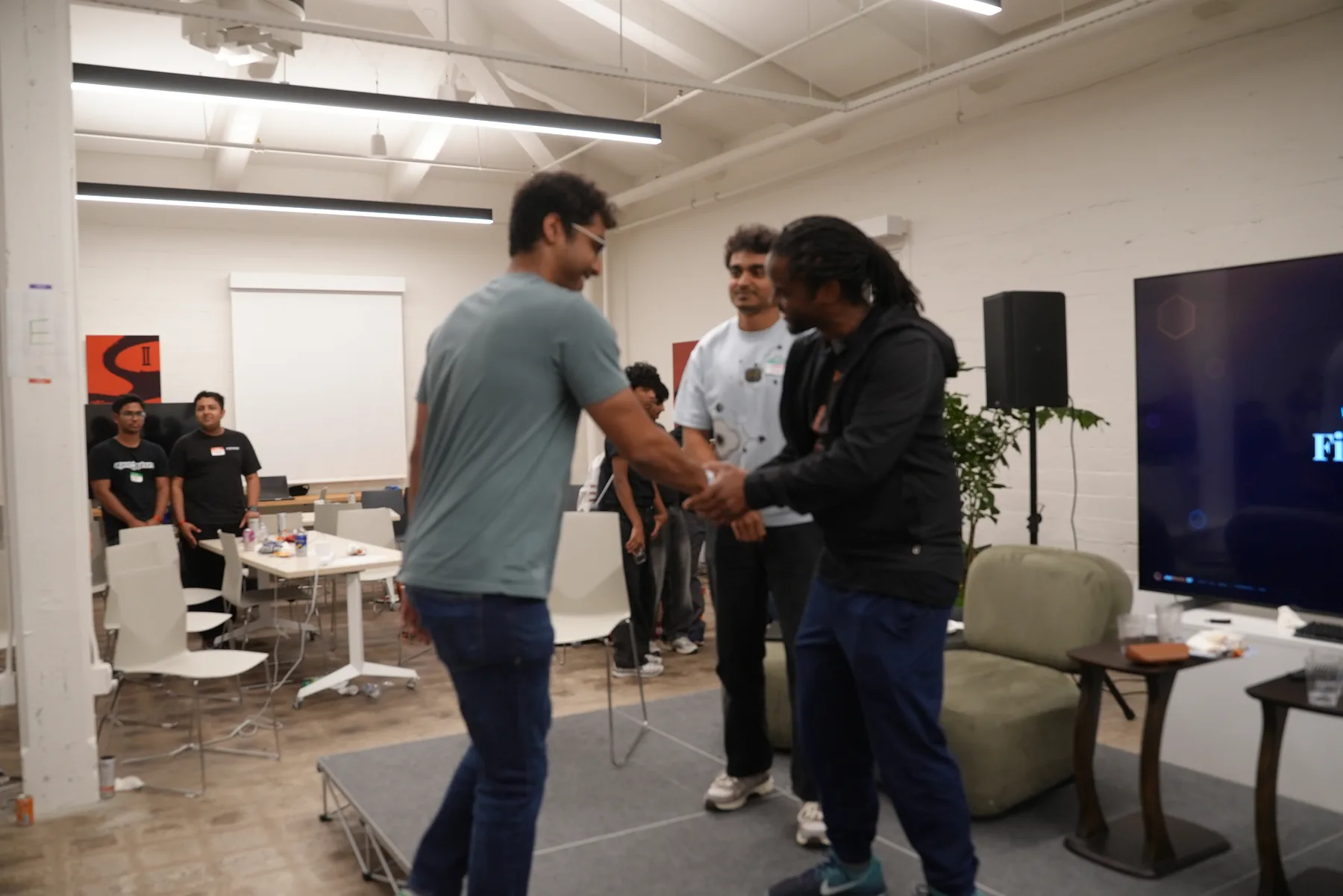 Organizers congratulating a team