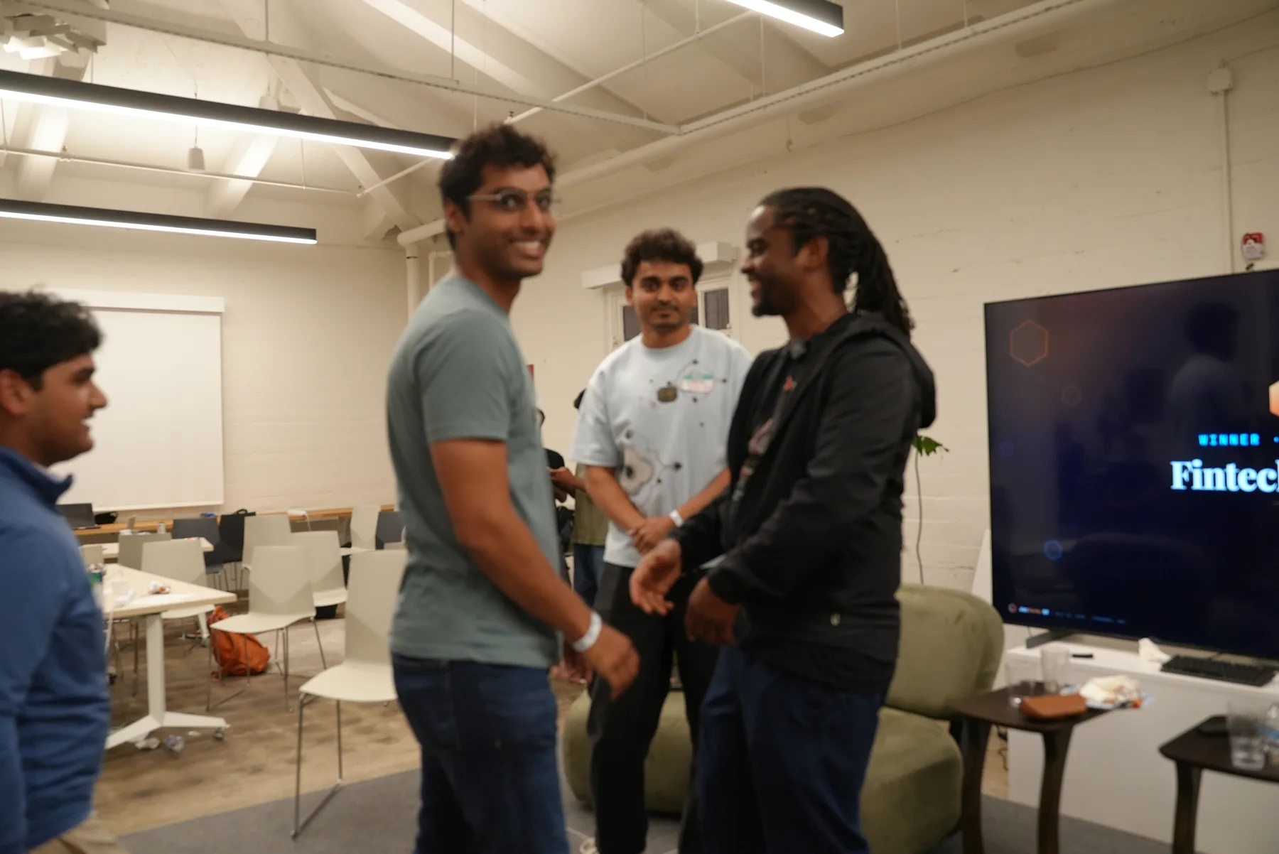 Organizers congratulating a team