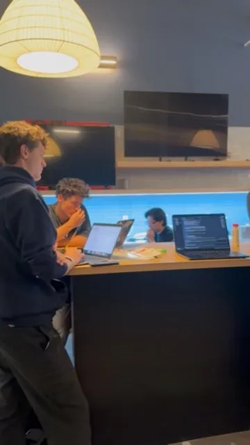 Hackers working at the counter at JacHacks SF